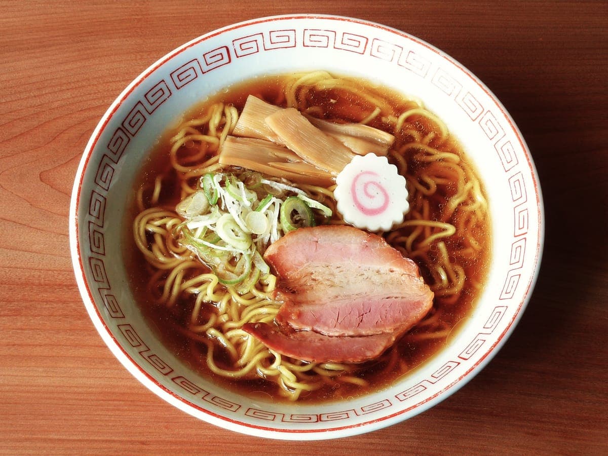 A bowl of shoyu ramen with pork, bamboo shoots and fish cake