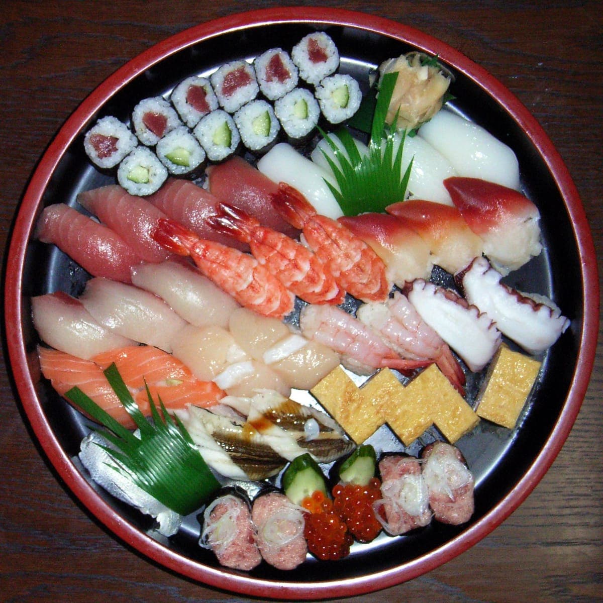 A round platter of assorted sushi